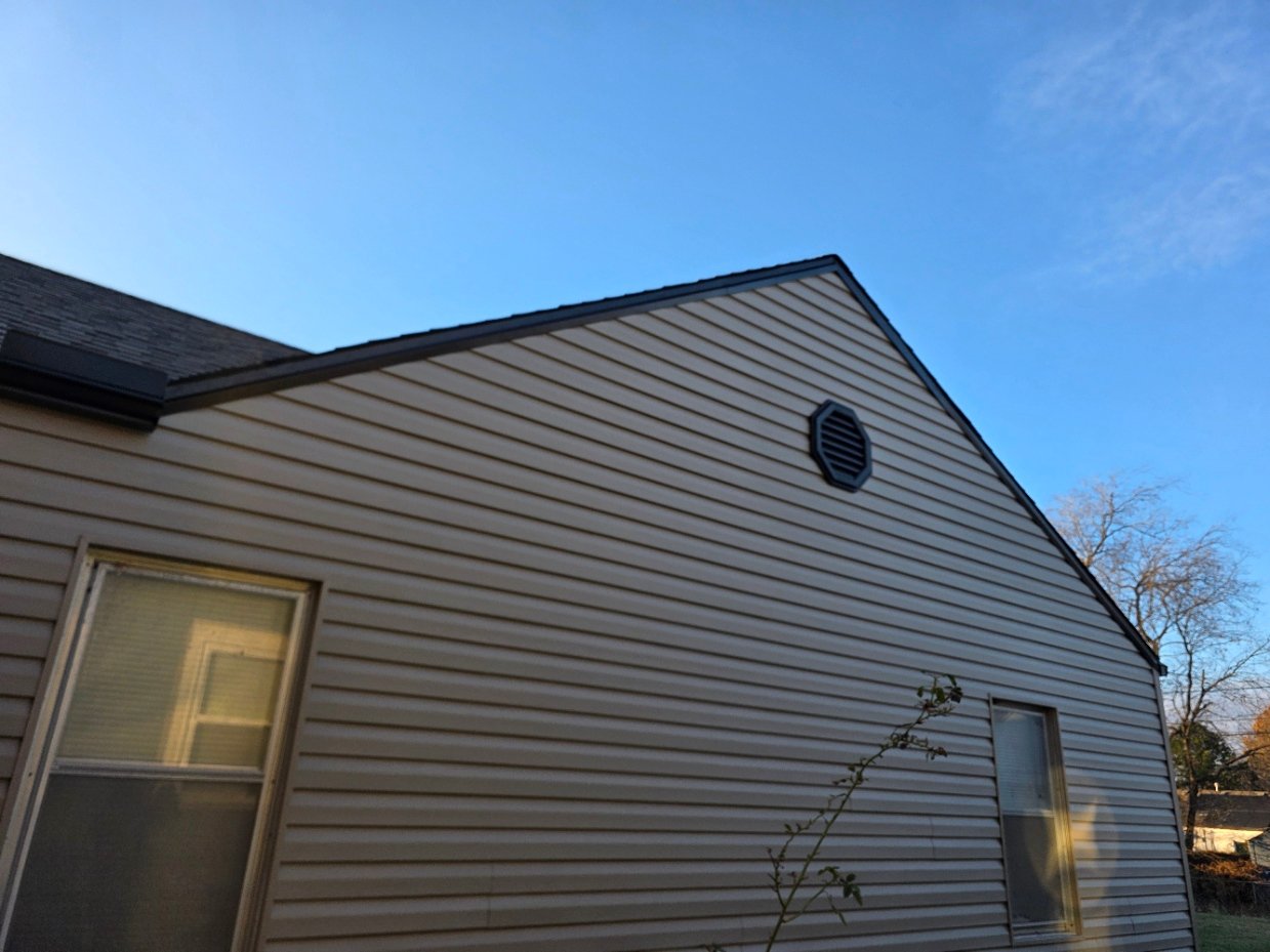 Custom fabricated fascia metal installed over drip edge and extended down on top of siding to shed water outward
